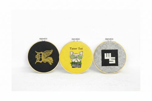 Three custom embroidered hoops with unique designs 